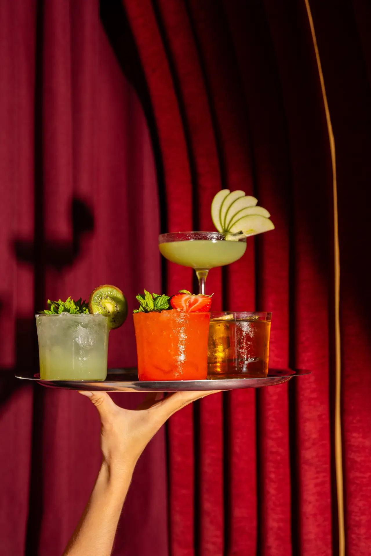 Signature cocktails on a brass tray